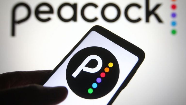 KYIV, UKRAINE - OCTOBER 31, 2021: In this photo illustration Peacock logo is seen on a mobile phone and a computer screen. (viewimage/shutterstock)